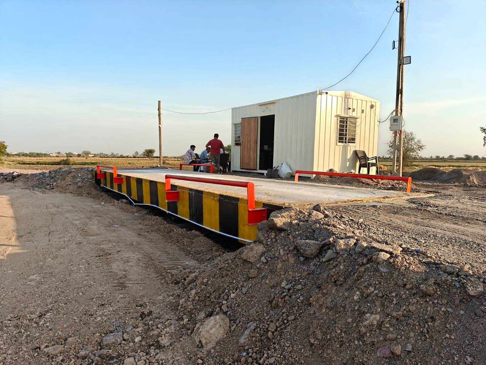 Concrete deck in a blue steel frame, with weigh cabin
